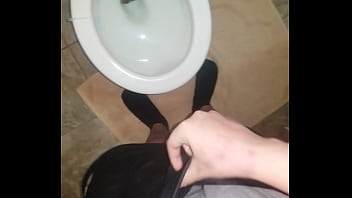 pissing into toilet